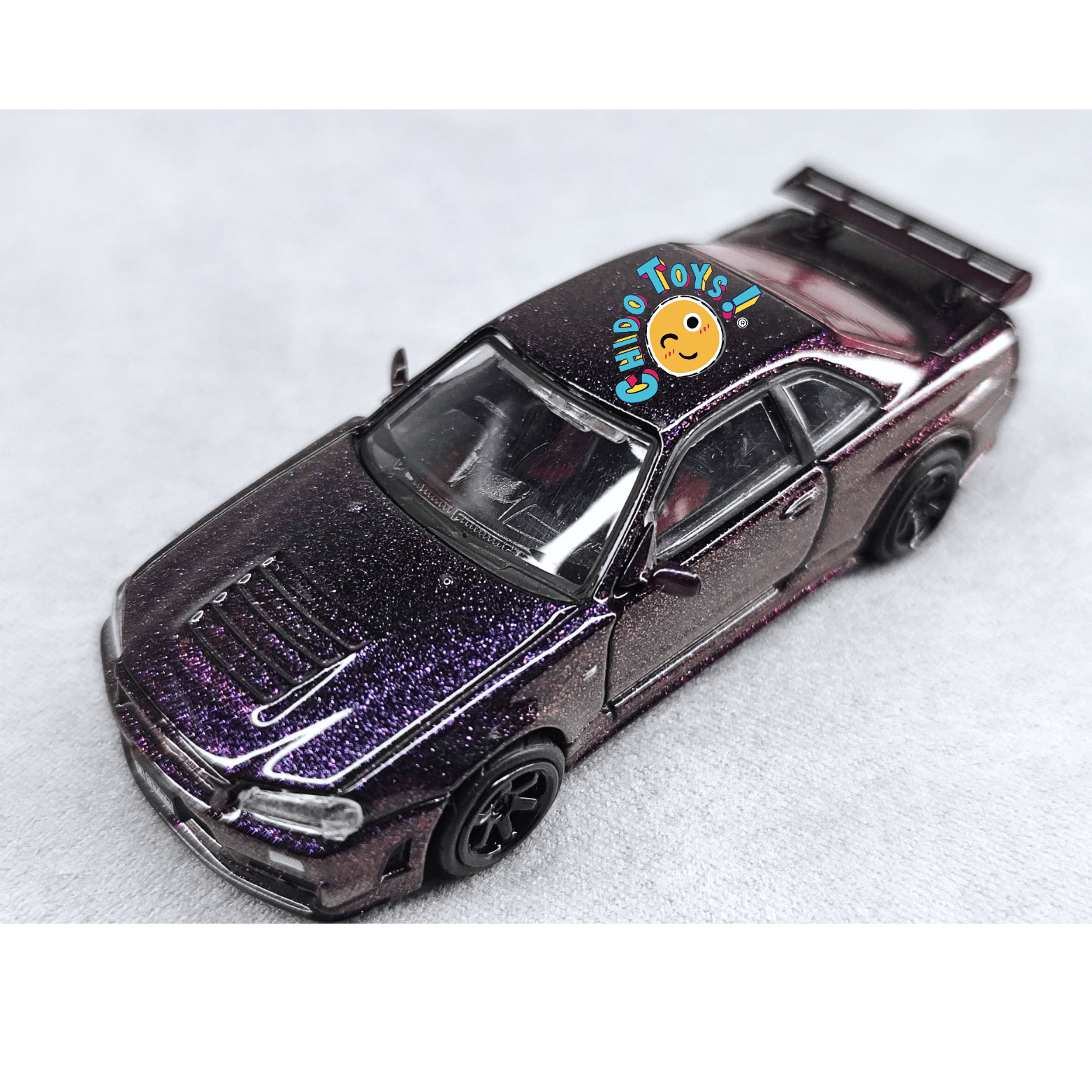 Auto a escala 1:64 TopArt Nissan Skyline GT - R R34 Z - Tune Camaleón con Base y Capelo - Chido Toys