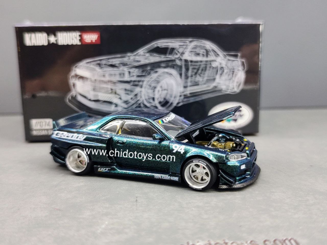 Auto a escala marca Mini GT, Modelo Nissan Skyline GT - R (R34) Kaido Works GReddy - Chido Toys
