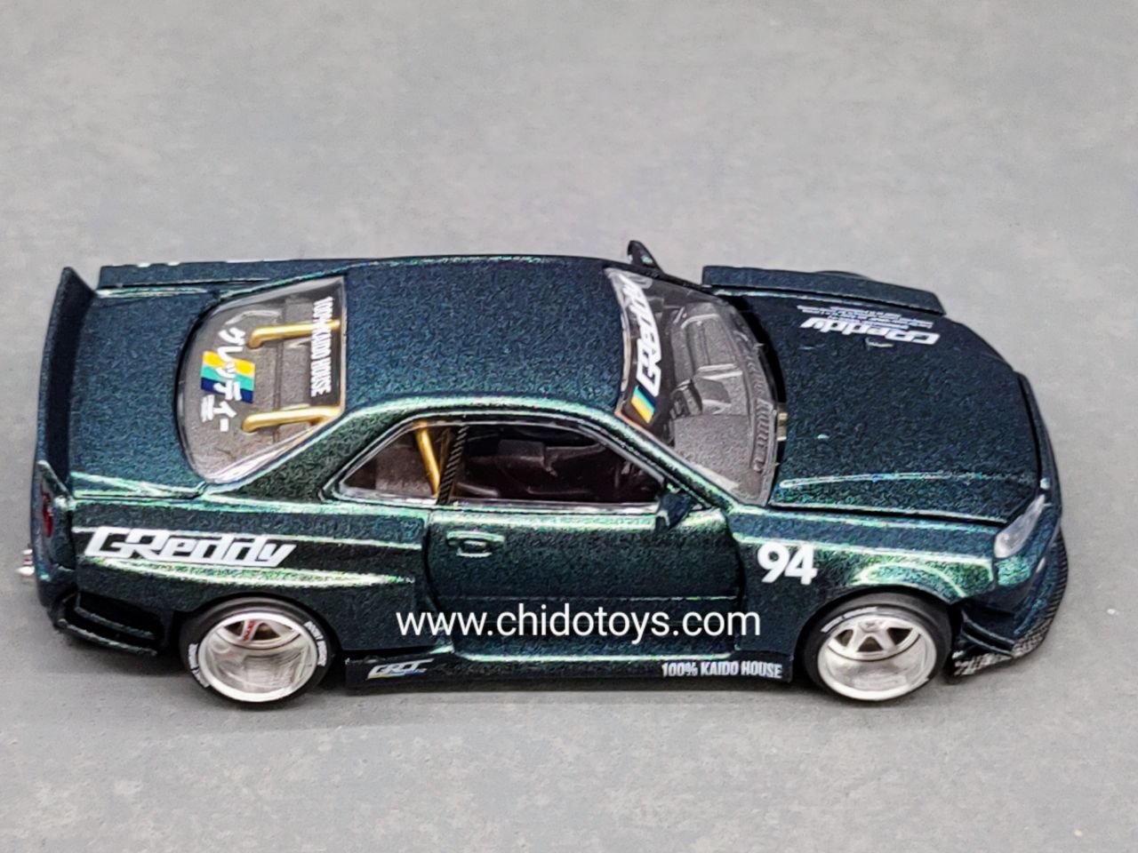 Auto a escala marca Mini GT, Modelo Nissan Skyline GT - R (R34) Kaido Works GReddy - Chido Toys