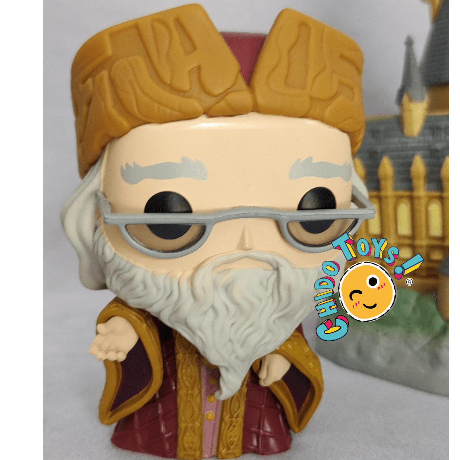 Figuras de vinyl, marca Funko, modelo Albus Dumbledore with Hogwarts - Chido Toys