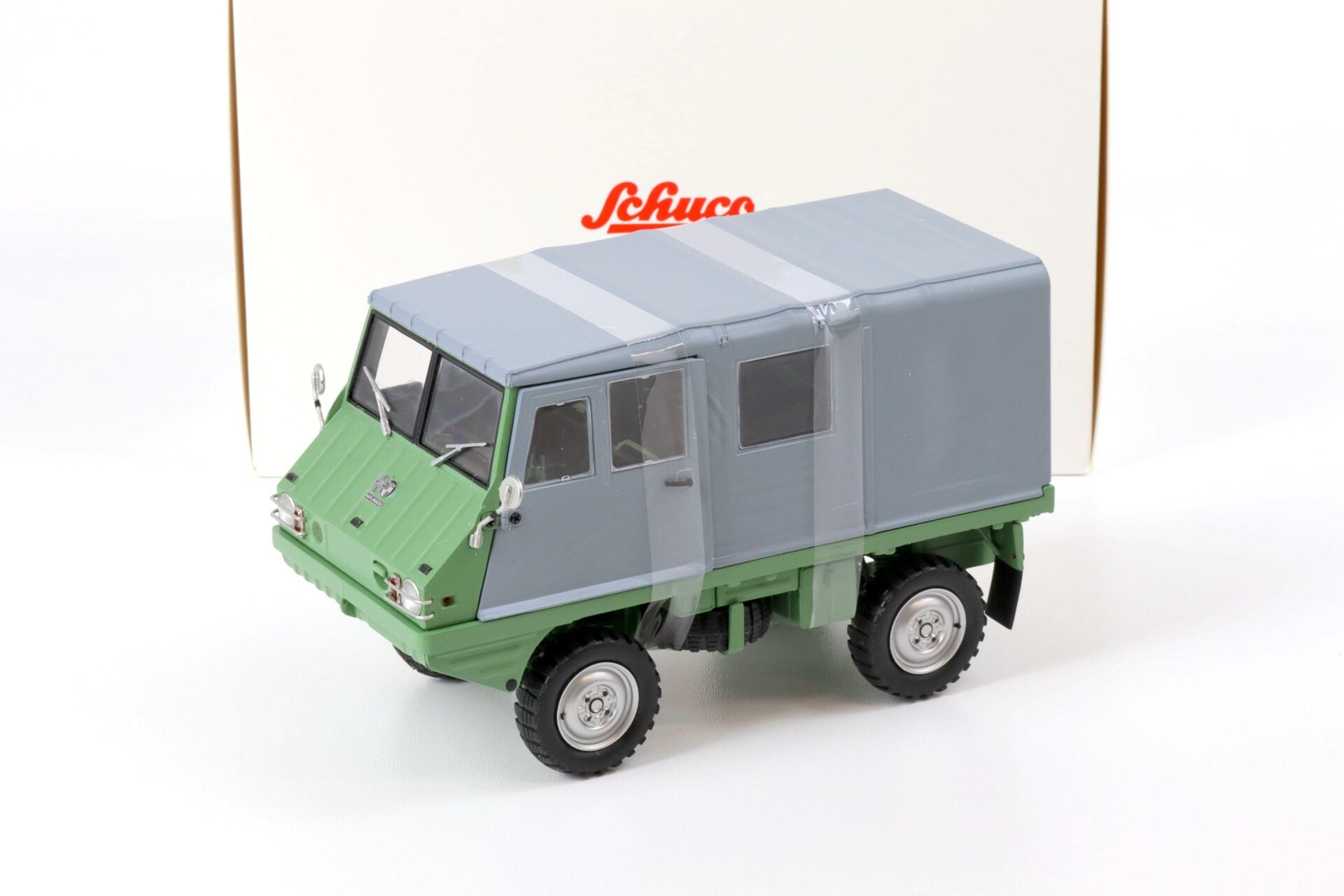 Schuco Steyr-Puch Haflinger 1:18 verde y gris, 23 cm, edición limitada a 2,000 piezas con llantas de goma y caja original.