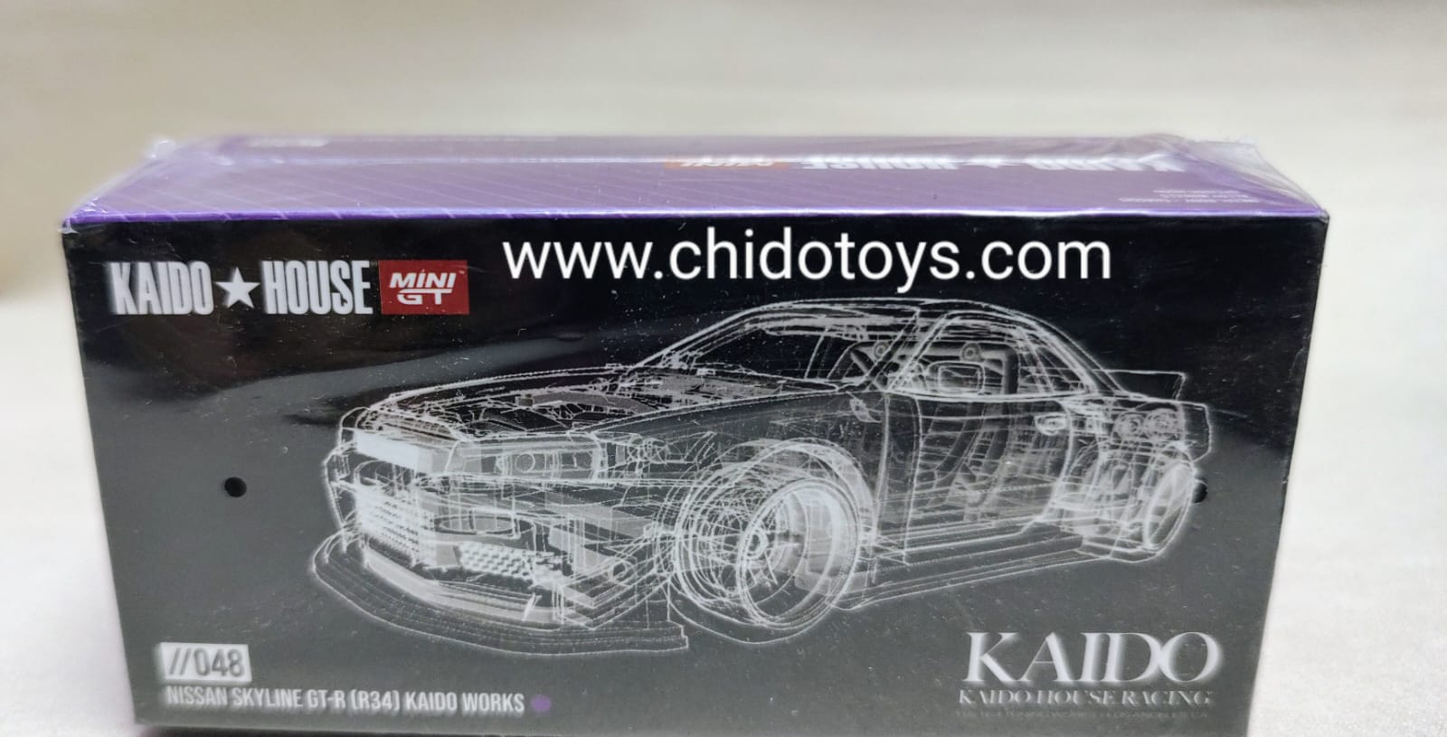 Auto a escala marca Kaido House & Mini GT, Modelo Nissan Skyline GT - R (R34) 048 - Chido Toys