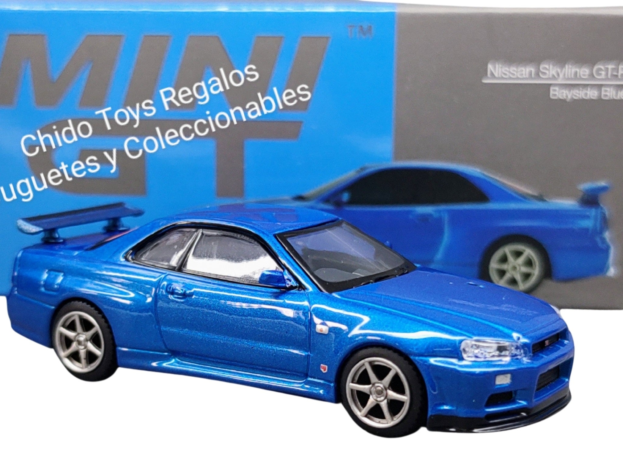 Auto a escala marca Mini GT Nissan Skyline GT - R (R34) V - Spec II Bayside - Chido Toys